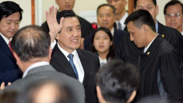 Taiwan President Ma Ying-jeou waves to his ruling Kuomintang (KMT) party colleagues after resigning as chairman in Taipei on December 3