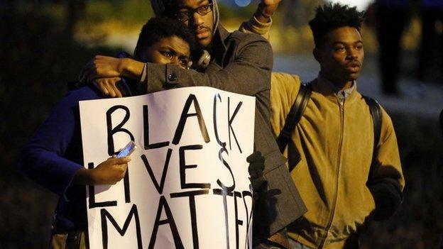 Protesters take part in a protest over the shooting death of Michael Brown in Webster Grove, Missouri