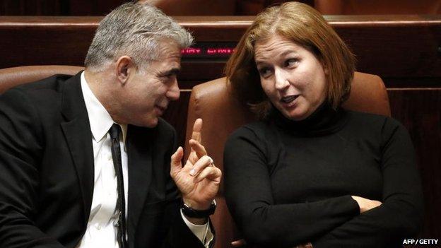 Yair Lapid and Tzipi Livni chat at the Knesset in Jerusalem in December 2014