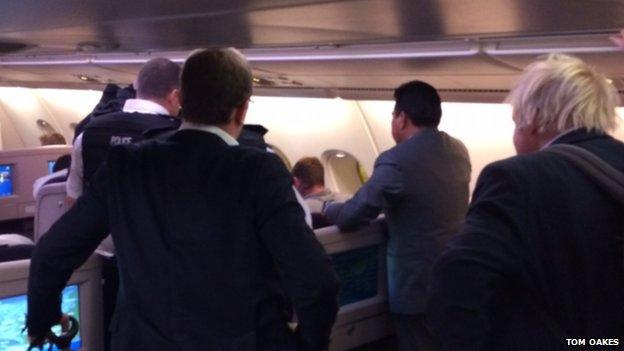 Boris Johnson and police onboard a plane