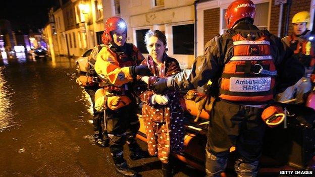 Woman with ambulance services during flooding in Lincolnshire