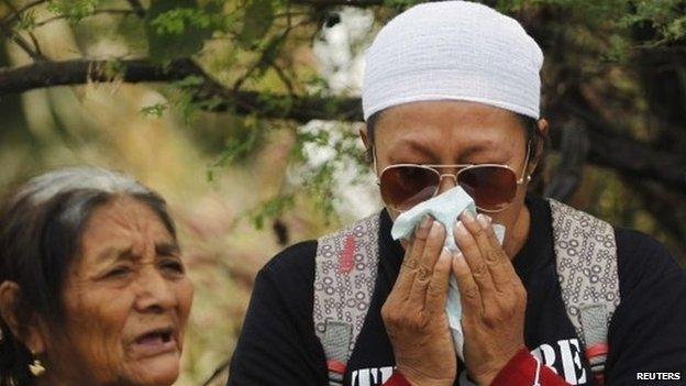 A woman with missing relatives is struck by grief during a religious mass before a search in a graves zone discovered in October outside Iguala, in Guerrero state on 29 November 2014.