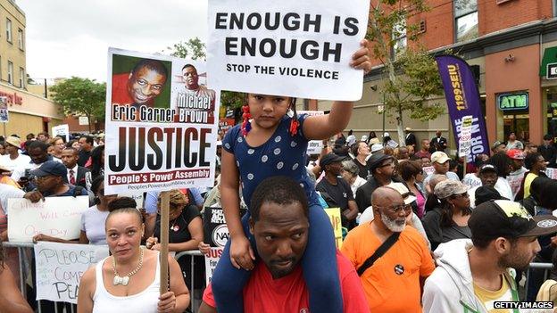 Demonstrators rallied against police brutality in memory of Eric Garner in New York on 23 August 2014