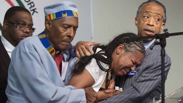 Esaw Garner, centre, wife of Eric Garner, breaks down in the arms of Rev Herbert Daughtry and Rev Al Sharpton