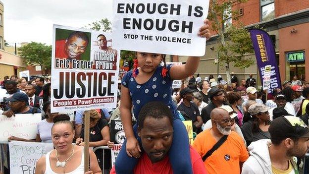 Demonstrators rallied against police brutality in memory of Eric Garner in New York on 23 August 2014