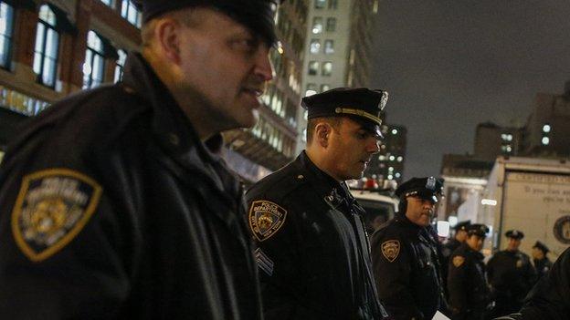 New York City police watch protestors following the announcement that Daniel Pantaleo will not be indicted.