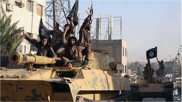 Islamic State militants drive a tank through Raqqa, Syria (undated image)