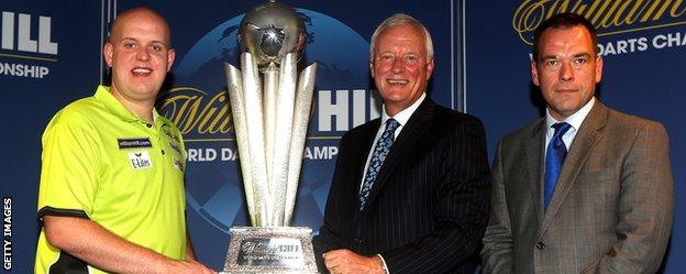 Barry Hearn (centre) with the Sid Waddell trophy at a World Darts Championship sponsorship launch in London