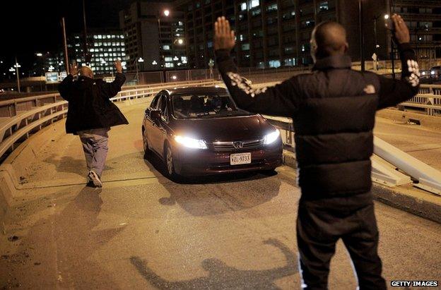 Protesters block a car in Washington DC, 3 December