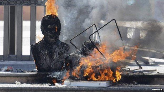 Busts of former Guerrero governors burn outside City Hall during a protest in Chilpancingo on 3 December, 2014