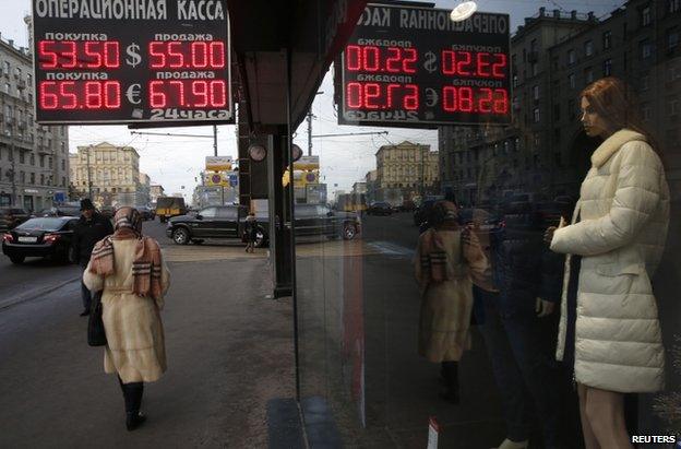 A Moscow street shows exchange rates, 3 December