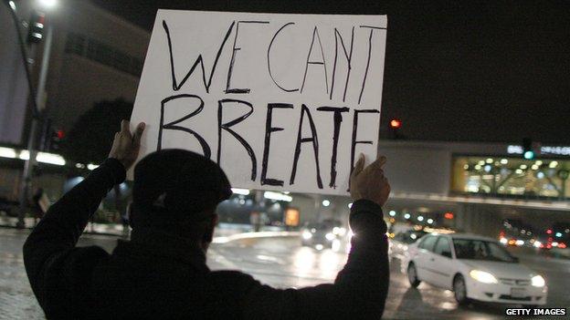 protesters holds we can't breathe masks