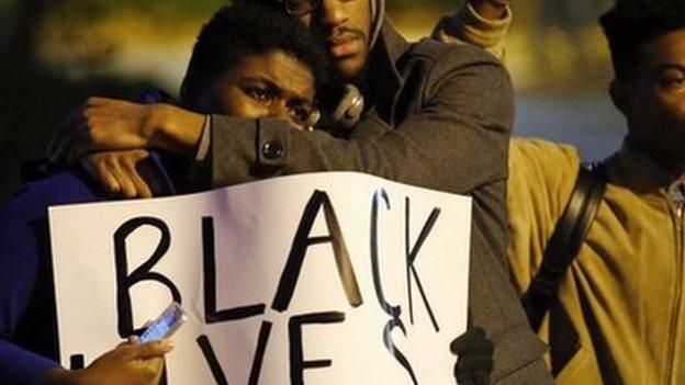 Protesters take part in a protest over the shooting death of Michael Brown in Webster Grove, Missouri