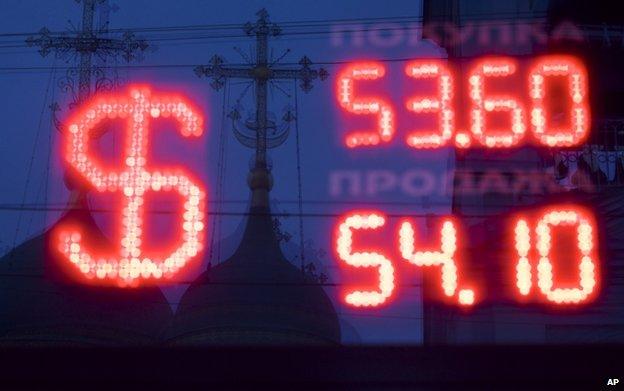 Crosses are reflected in the window of a bureau de change in Moscow, 4 December