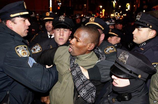 Police make an arrest at a protest in Midtown, New York, 5 December