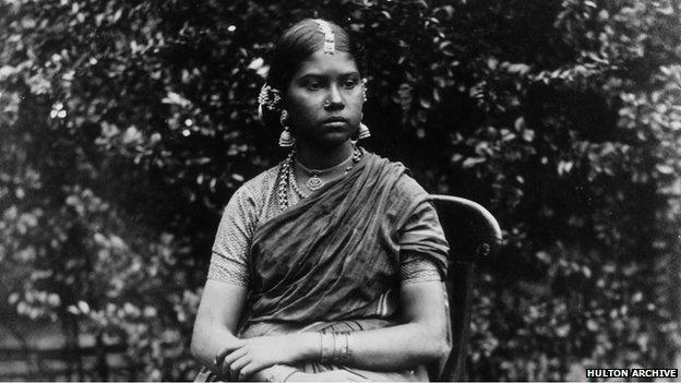 A young Indian woman wearing a sari and an array of jewellery. - c1810