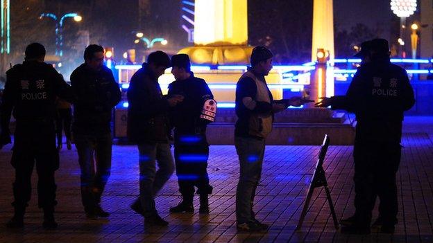 Han Chinese officers conduct a stop and search