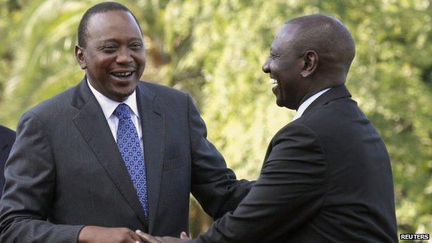 Kenyan President Uhuru Kenyatta (L) shares a moment with his Deputy William Ruto (R) at the State House after Kenyatta's case at the International Criminal Court (ICC) was dropped in the capital Nairobi