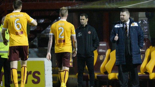 Motherwell general manager Alan Burrows (far right) congratulates the team after victory over Dundee United.