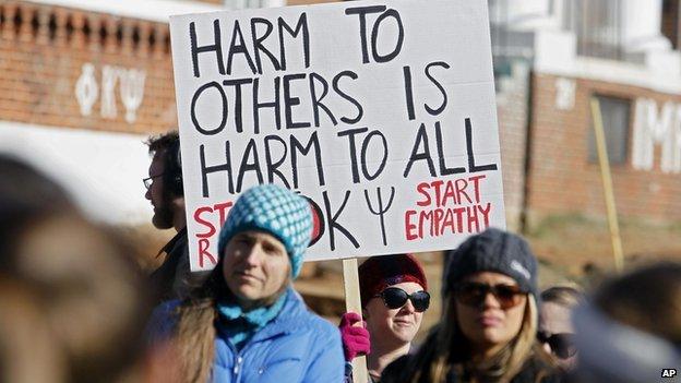 Protestors gather outside the Phi Kappa Psi fraternity house at the University of Virginia.