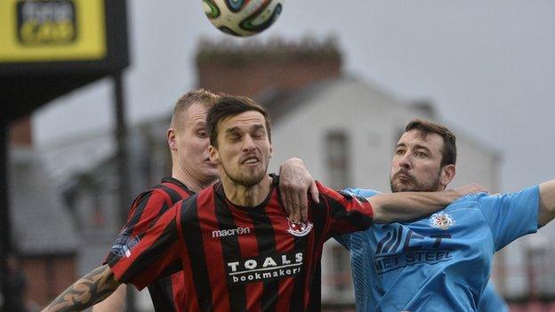 Crusaders midfielder Declan Caddell battles with Portadown goal-scorer Michael Gault at Seaview