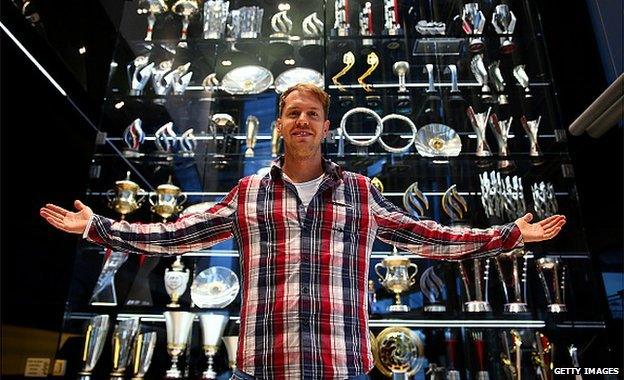 Sebastian Vettel with the trophy cabinet at Red Bull