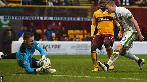 Motherwell goalkeeper Dan Twardzik makes a save following John Guidetti's shot