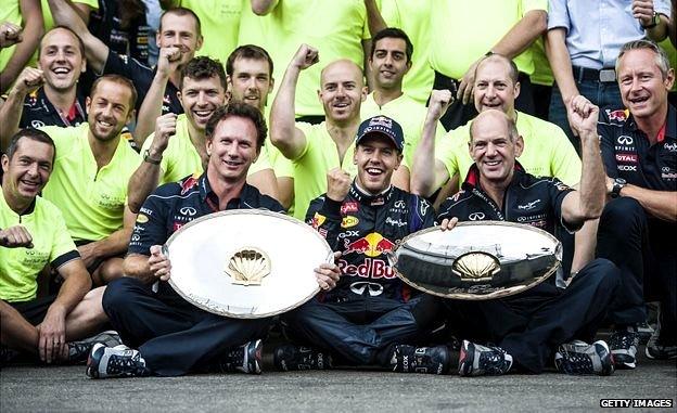 Red Bull Racing German driver Sebastian Vettel (C), Team Principal Christian Horner (L), and chief Technical Officer Adrian Newey (R), pose with their trophies after Vettel won the Belgium Formula One Grand Prix