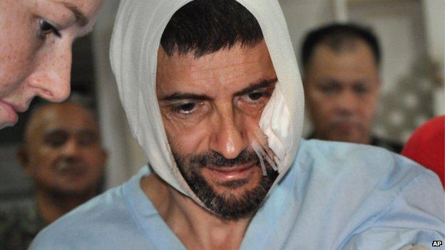 Swiss hostage Lorenzo Vinciguerra, is treated in a hospital following his daring escape from the hands of the Muslim Abu Sayyaf extremists, in Jolo in southern Philippines, Saturday, Dec. 6, 2014