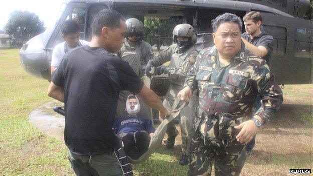 Lorenzo Vinciguerra, a Swiss wildlife photographer who was kidnapped by Islamist rebels more than two years ago, is carried by soldiers to Camp Bautista Station Hospital in the municipality of Jolo, province of Sulu, southern Philippines in this December 6