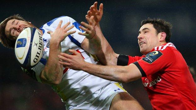 Munster's Felix Jones battles with Clermont Auvergne's Camille Lopez at Thomond Park