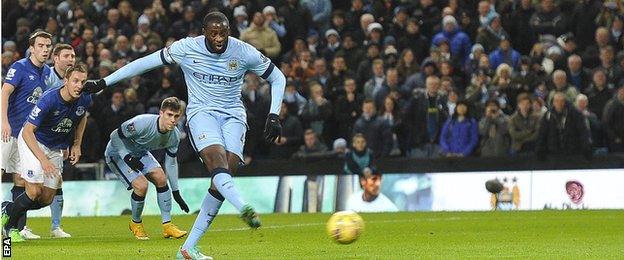 Manchester City midfielder Yaya Toure scores from the penalty spot against Everton