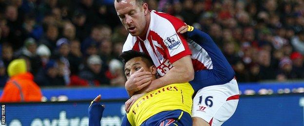 Charlie Adam wrestles Alexis Sanchez for the ball