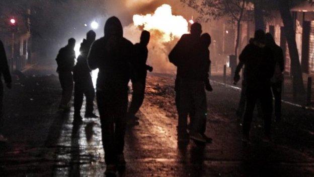 Protesters throw molotov cocktaisl at riot policemen during clashes in Athens, Greece, 6 December 2014