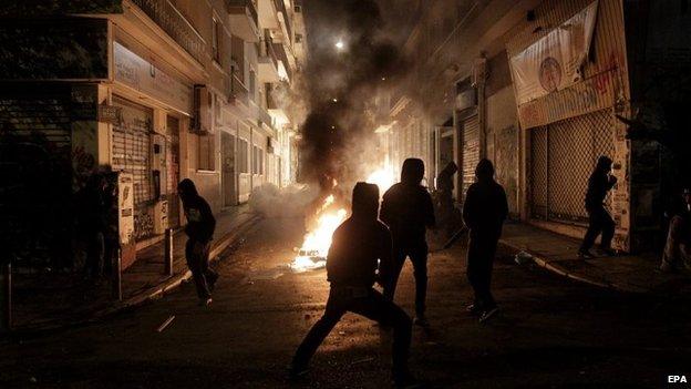 Protesters clash with riot policemen during a rally on the anniversary of the killing of teenager Alexis Grigoropoulos by a Greek police officer, in Athens, Greece, 6 December 2014