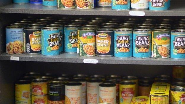 Tins of food stacked on a shelf