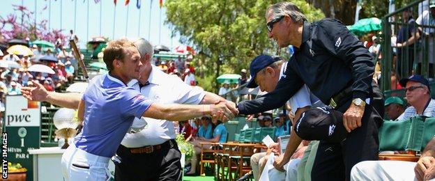 Dany Willett shakes hands with Gary Player before teeing off in the final round