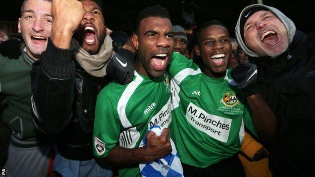 Worcester City players celebrate with fans after their 1-1 draw at Scunthorpe