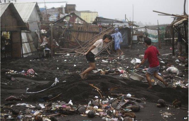 Residents clean a village near Legazpi, Philippines (8 Dec 2014)