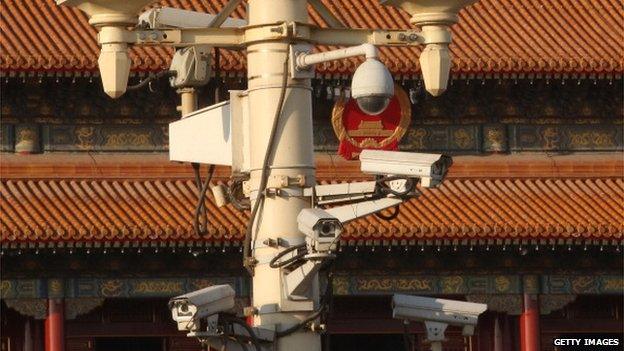 Security cameras hang on a lamp at the Tiananmen Square ahead on 1 March, 2014 in Beijing, China