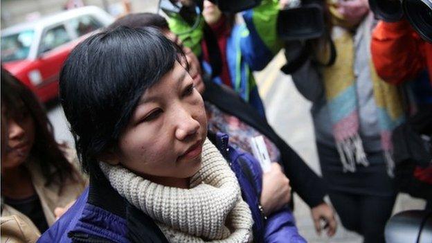 Erwiana Sulistyaningsih arrives at the Wanchai Law Courts to begin giving evidence against her former employer who is accused of abuse and torture in Hong Kong on 8 December 2014.