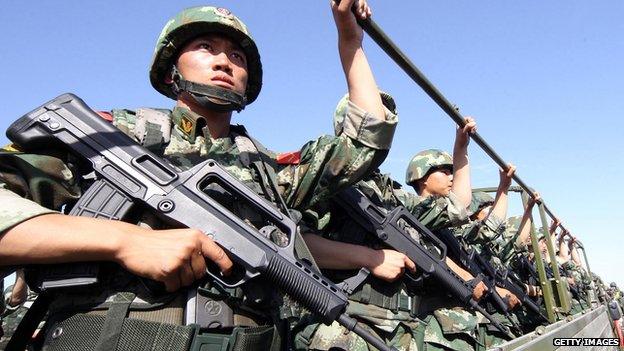 An anti-terrorism force including public security police and the armed police attend an anti-terrorism joint exercise in Hami, northwest China's Xinjiang region on 2 July, 2013