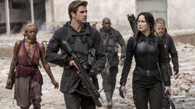 Liam Hemsworth and Jennifer Lawrence with other cast members of The Hunger Games: Mockingjay - Part 1