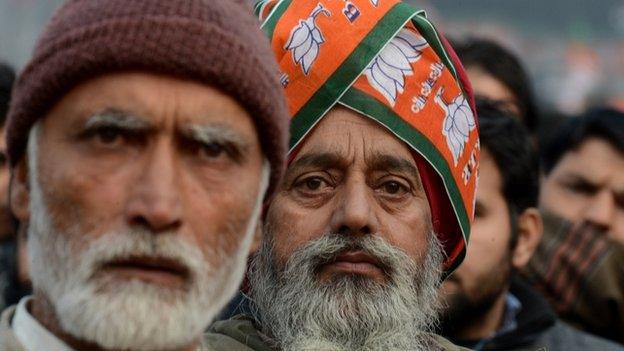 Kashmiri supporters of Modi look on as he speaks during an election rally at a stadium in Srinagar.