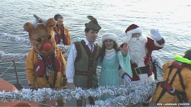 Santa and Poole's panto stars arrived by RNLI boat as has been happening in previous years