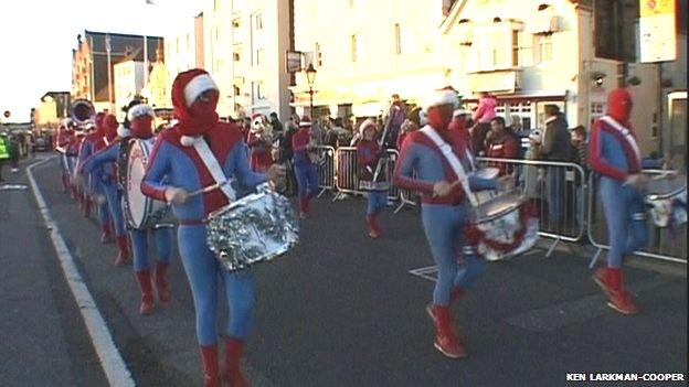 The procession included drum-playing Spider-Men