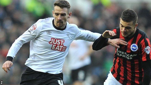 Craig Bryson (left) fends off Brighton's Jake Forster-Caskey