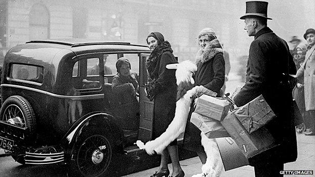 Christmas shoppers are helped into a taxi by the doorman at Whiteleys in west London in the 1920s