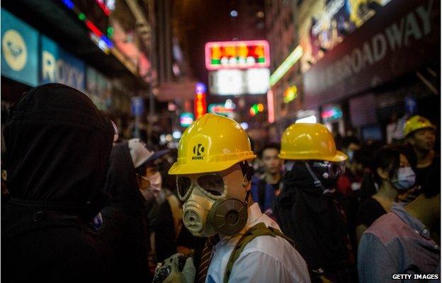 A pro-democracy activist is seen wearing a gas mask on a street in Mong Kok on November 26, 2014 in Hong Kong