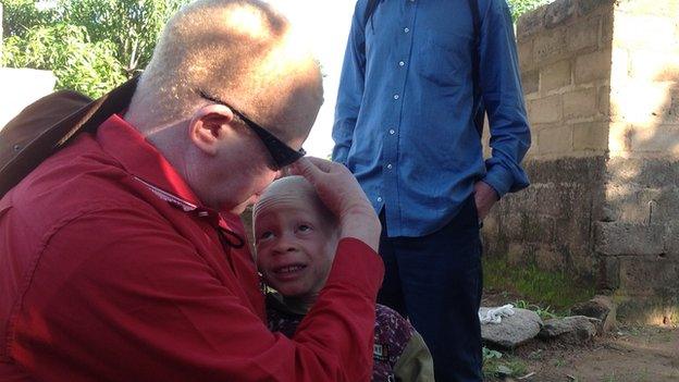 A fcommunity leader with a child in Ukerewe island, Tanzania (December 2014)